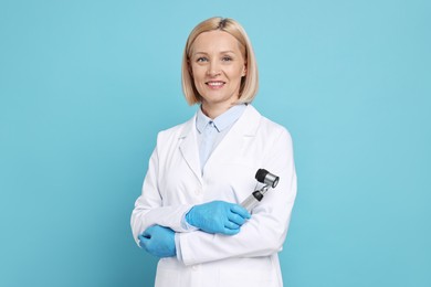 Happy dermatologist with dermatoscope on light blue background