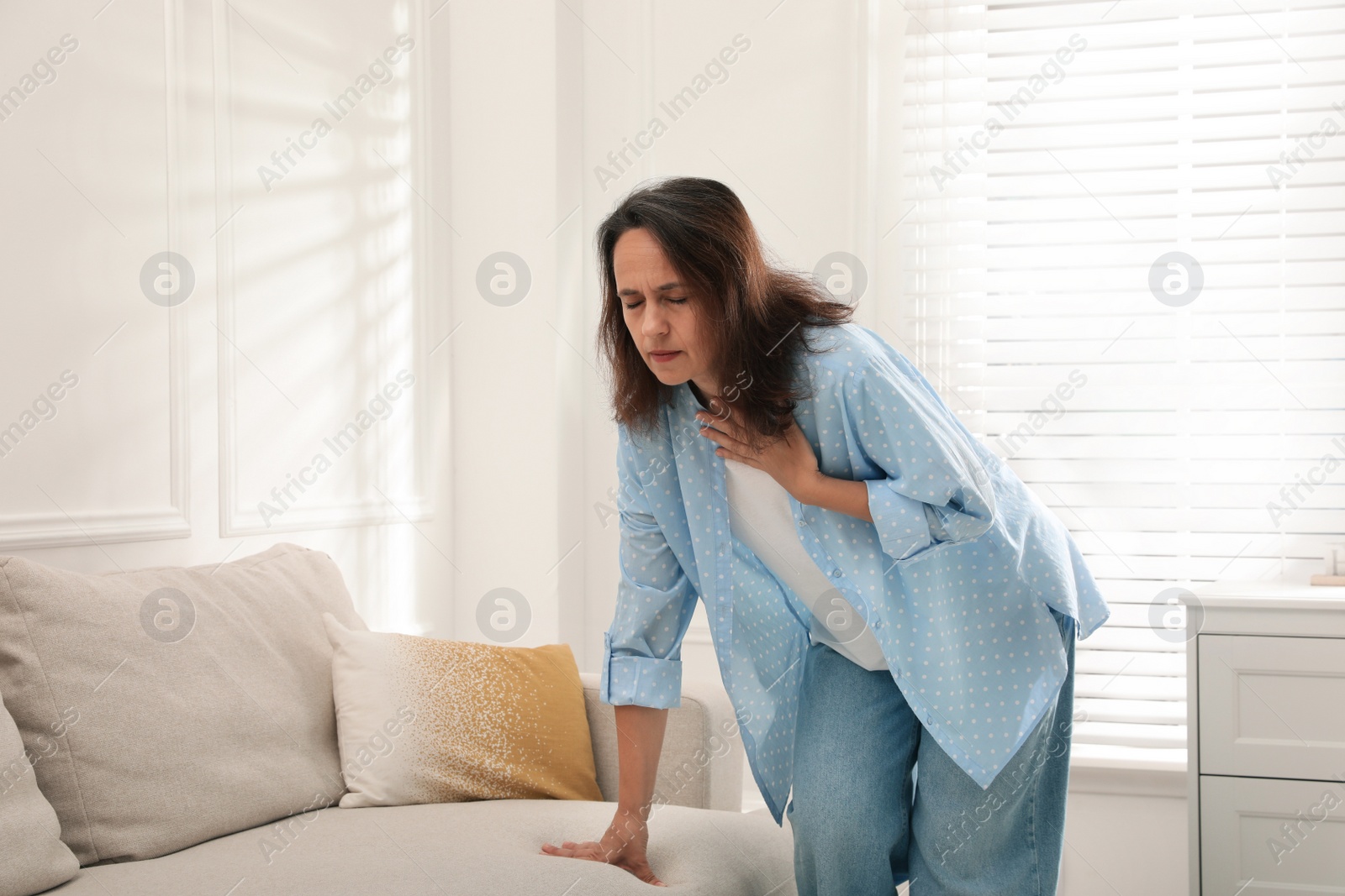 Photo of Mature woman suffering from breathing problem at home