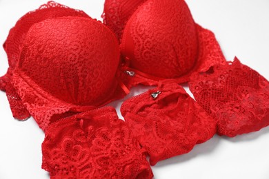 Photo of Stylish red women's underwear on white background, closeup