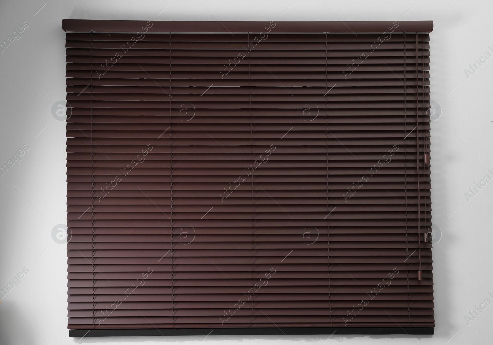 Photo of Stylish horizontal window blinds on white wall