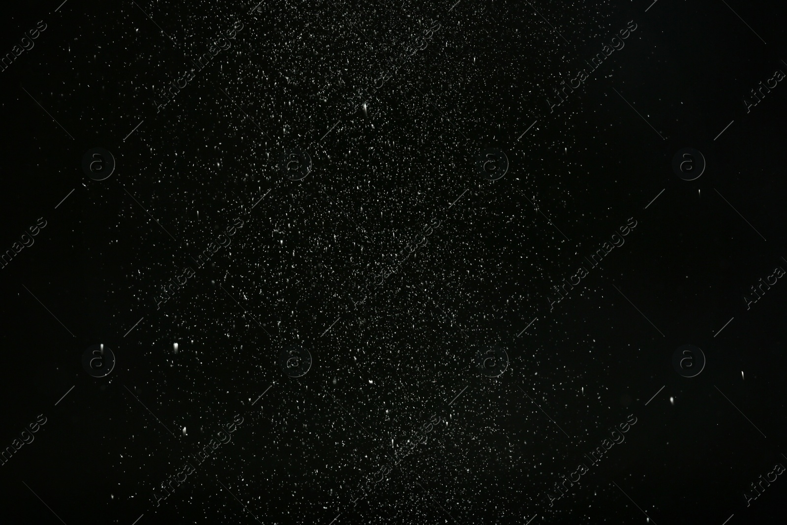 Photo of Snow flakes falling on black background. Winter weather