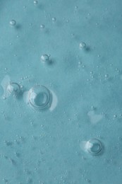 Photo of Cosmetic serum on light blue background, top view