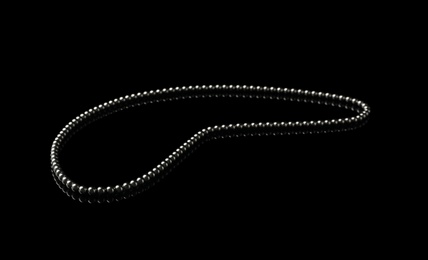 Photo of Chain of small magnetic balls on black background