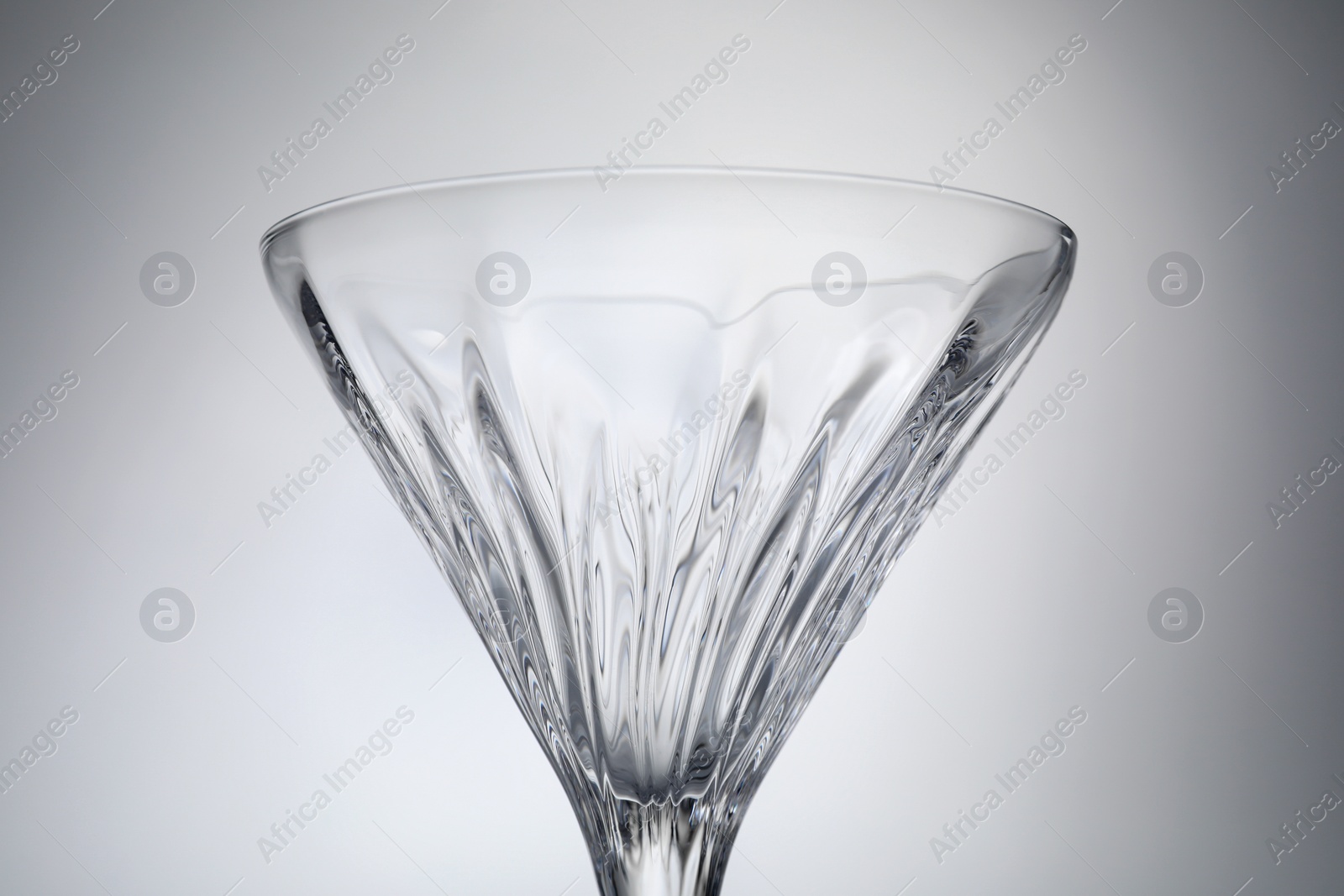 Photo of Elegant empty martini glass on grey background, closeup