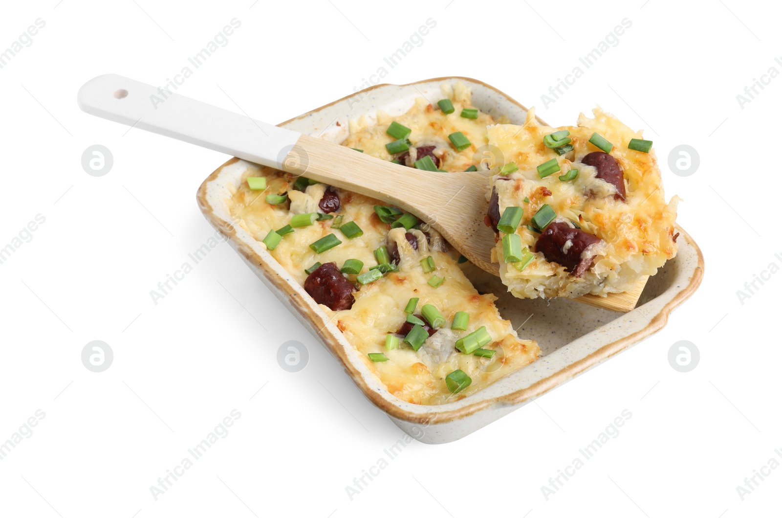 Photo of Taking piece of tasty sausage casserole with green onion from baking dish isolated on white