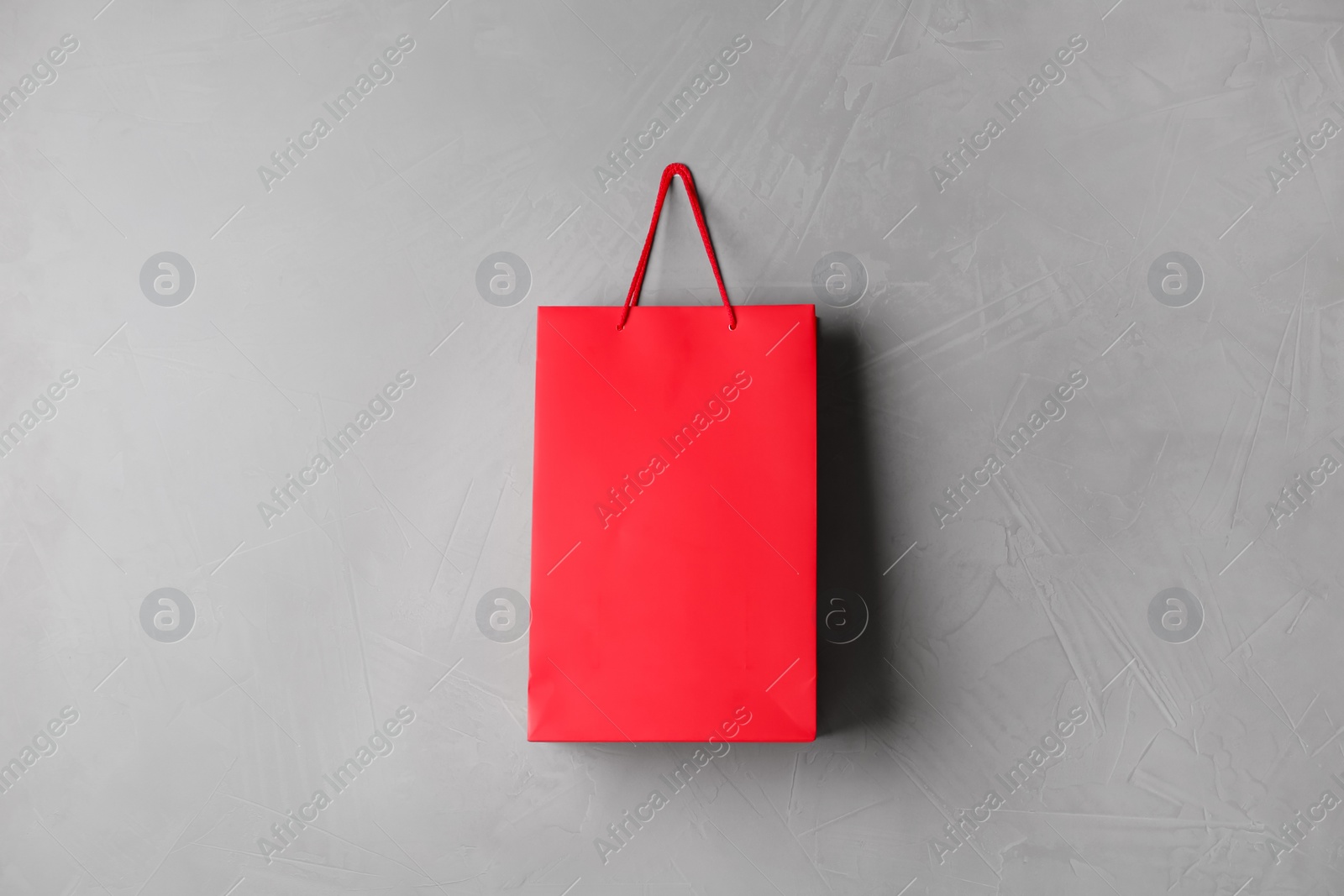 Photo of Paper shopping bag hanging on grey wall