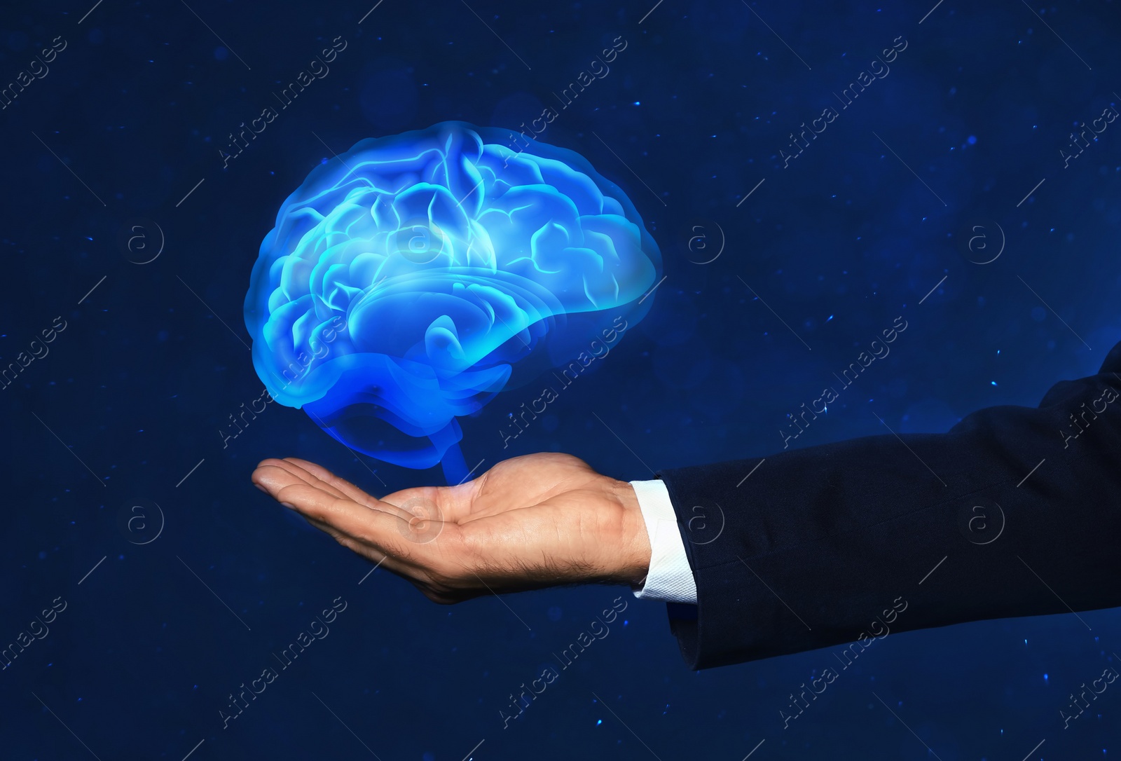 Image of Young man holding digital image of brain on blue background, closeup