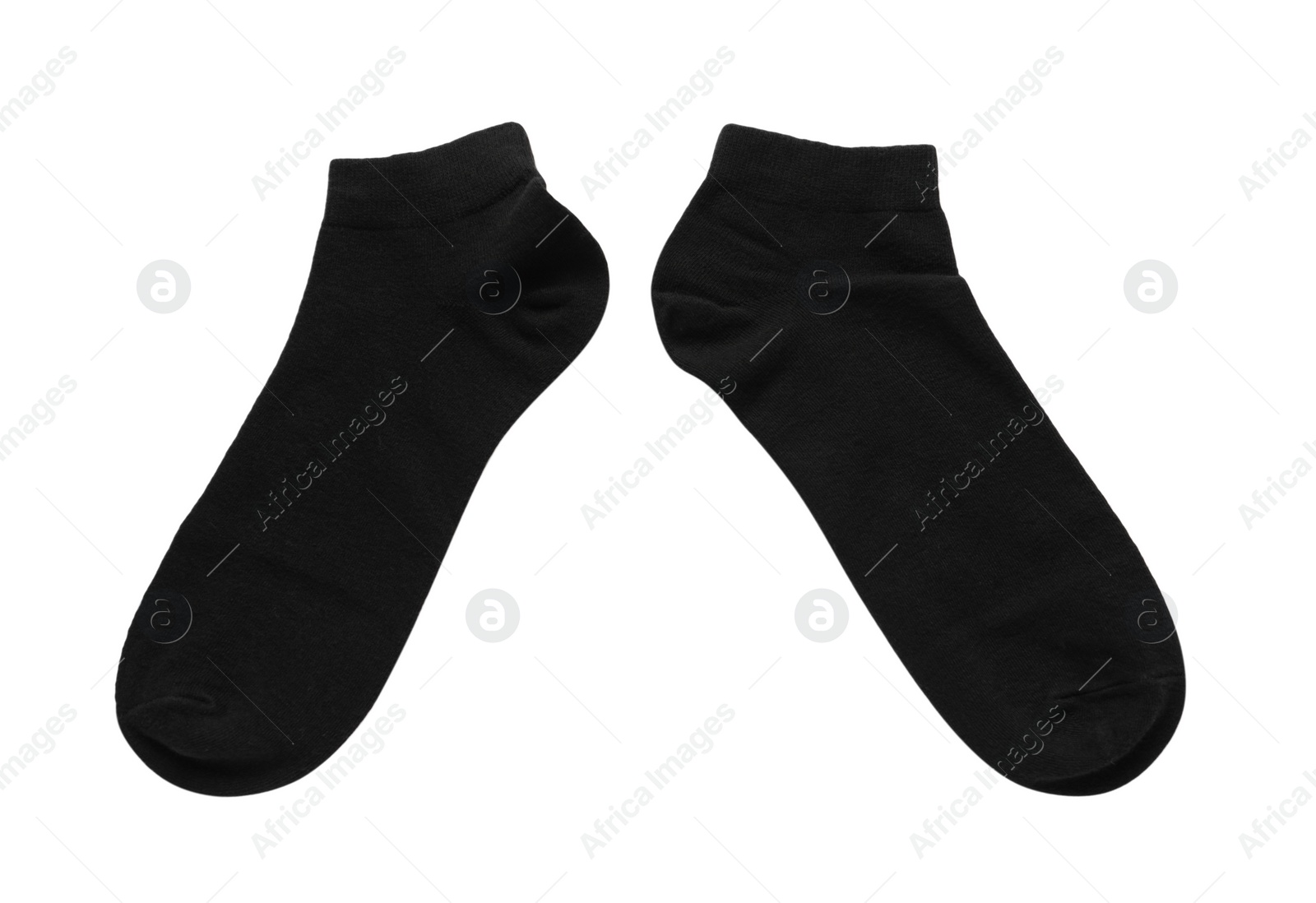 Photo of Pair of black socks on white background, top view