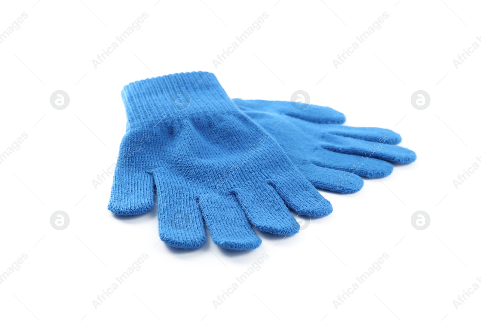 Photo of Blue woolen gloves on white background. Winter clothes