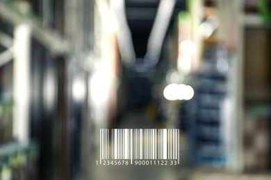 Image of Barcode and blurred view of modern wholesale warehouse