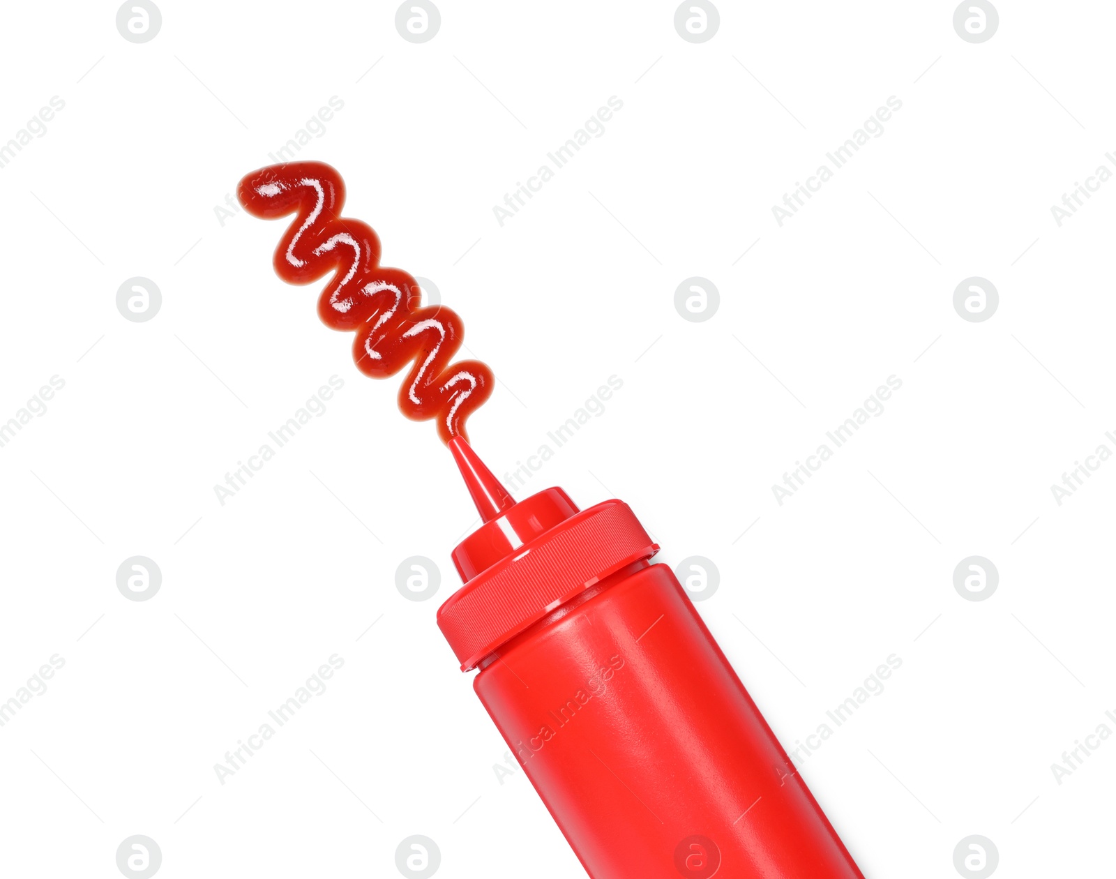 Photo of Squeezed ketchup from red bottle isolated on white, top view