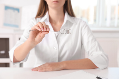 Speech therapist with logopedic probe in clinic, closeup