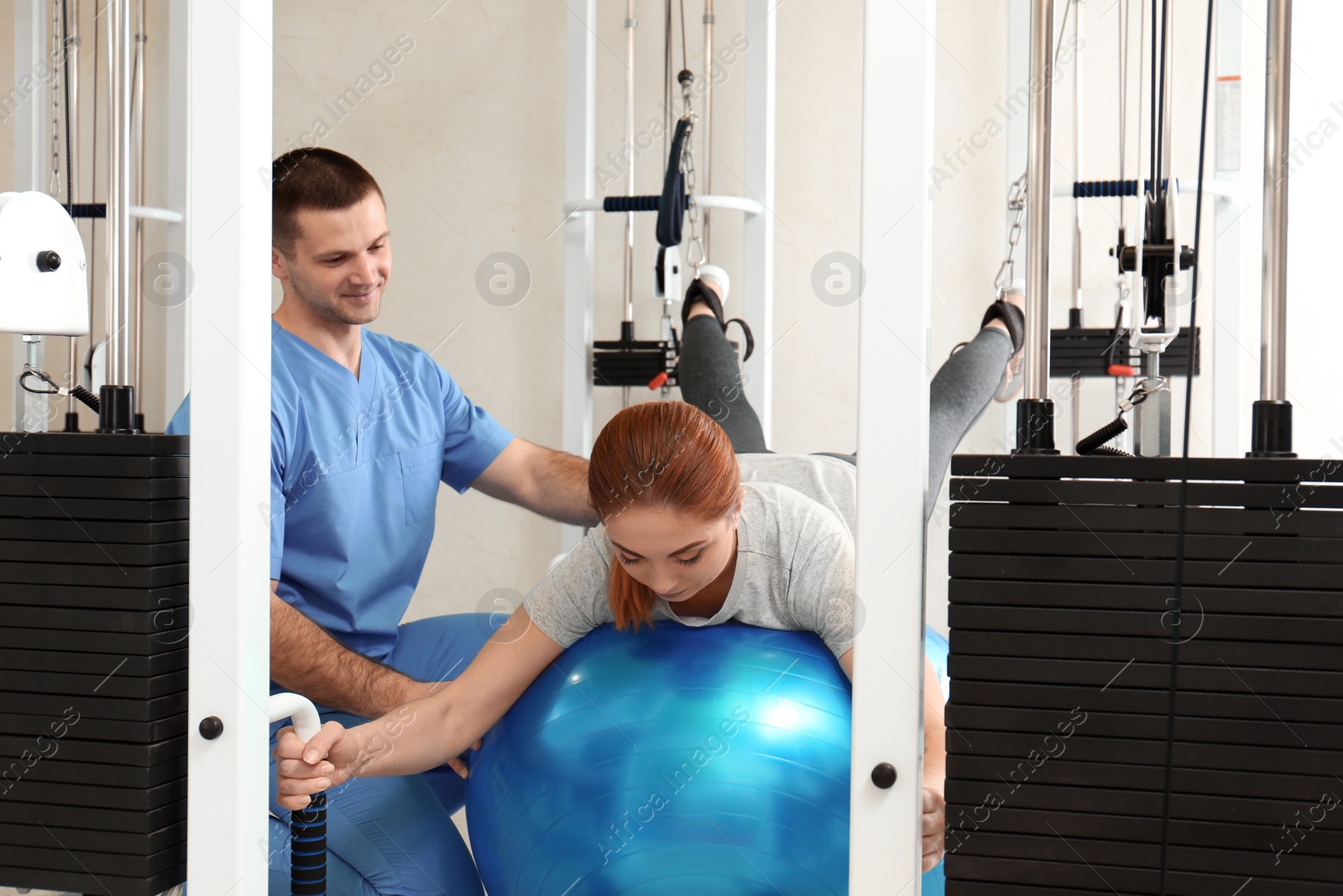 Photo of Patient exercising under physiotherapist supervision in rehabilitation center