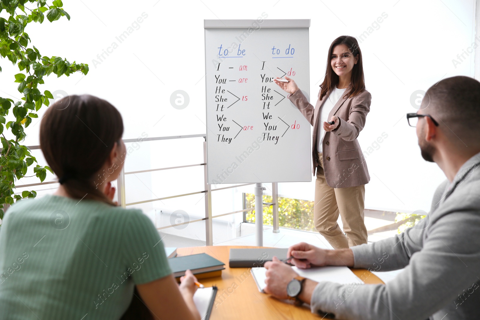 Photo of English teacher with students in class at lesson