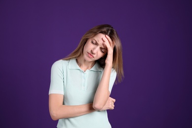 Photo of Portrait of stressed young woman on purple background