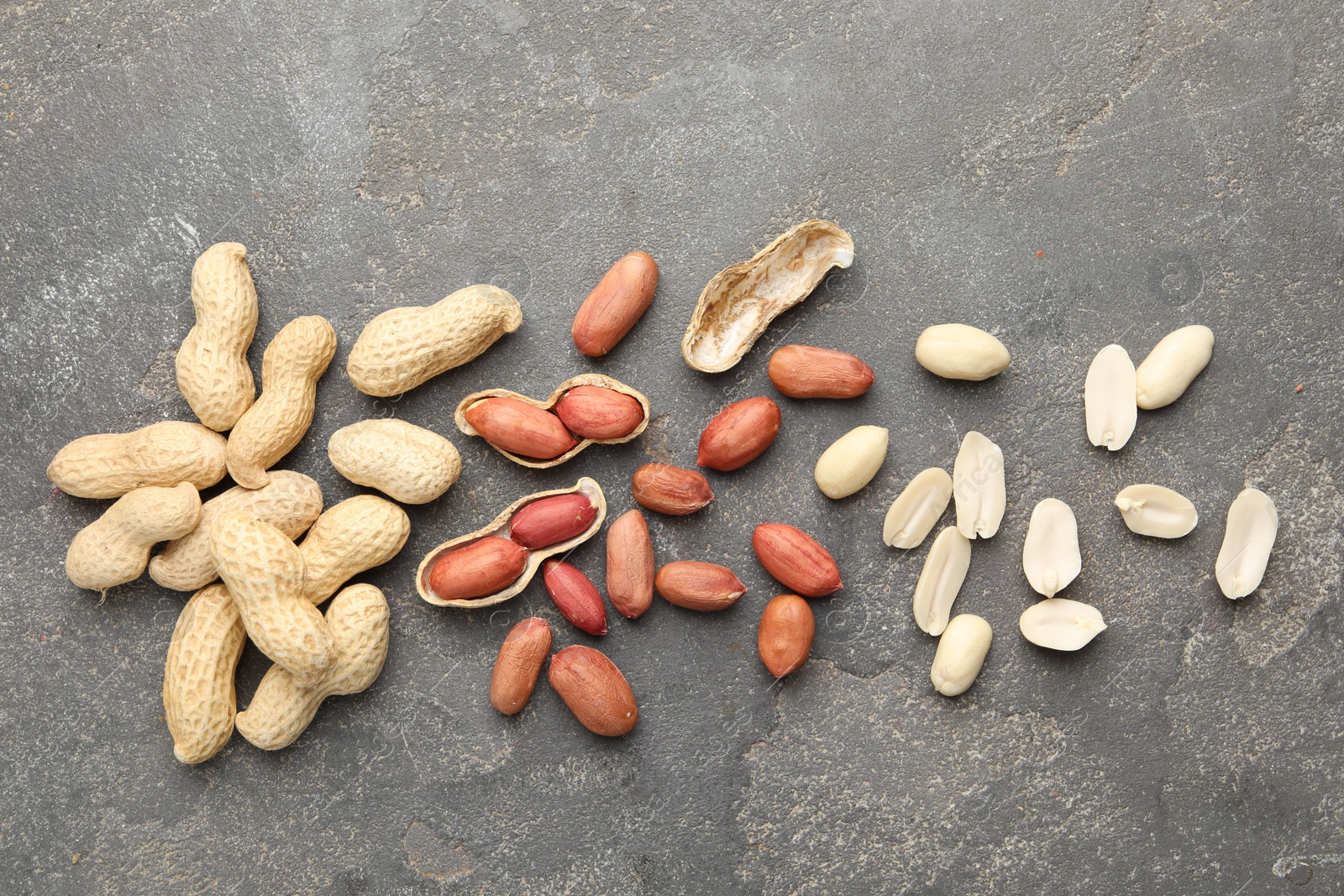 Photo of Fresh peanuts on grey table, flat lay