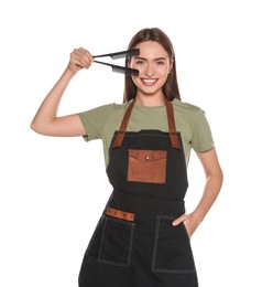 Photo of Portrait of happy hairdresser with combs on white background