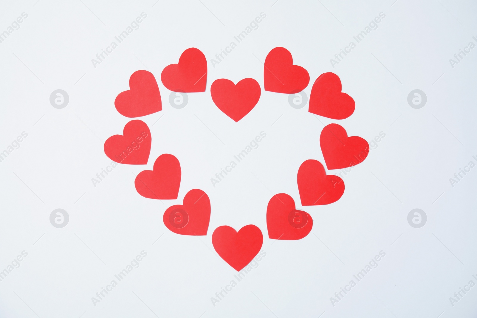 Photo of Composition made of small paper hearts on white background