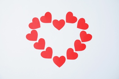 Photo of Composition made of small paper hearts on white background