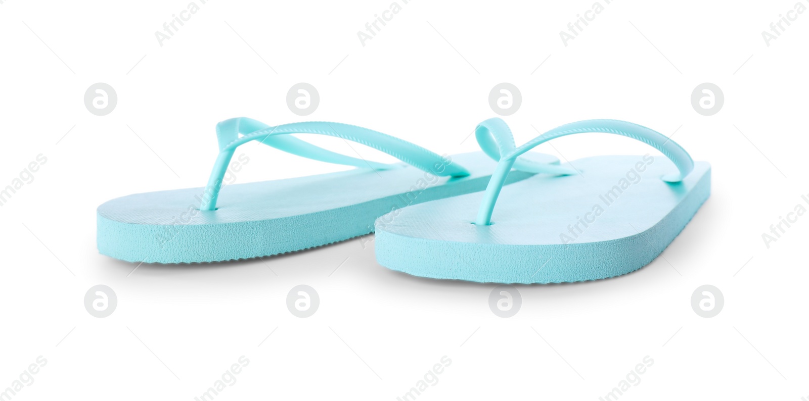 Photo of Light blue flip flops isolated on white. Beach accessory