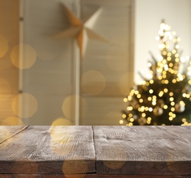 Image of Empty wooden surface and blurred view of room decorated for Christmas, space for text. Interior design