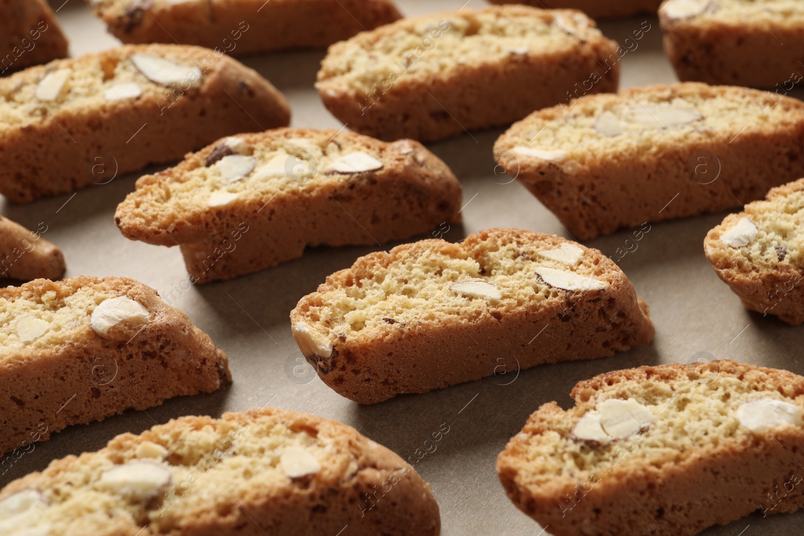 Photo of Traditional Italian almond biscuits (Cantucci) on parchment paper, closeup