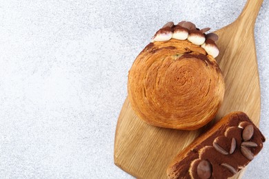 Photo of Tasty puff pastry. Supreme croissants with chocolate chips and cream on grey table, top view. Space for text