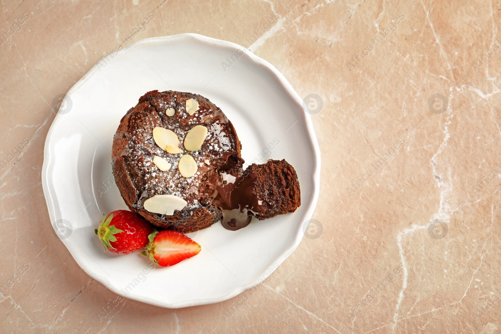 Photo of Plate of delicious fresh fondant with hot chocolate and strawberries on table, top view. Lava cake recipe