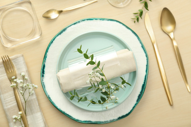 Photo of Elegant table setting with flowers and leaves, flat lay