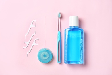 Flat lay composition with manual toothbrush and oral hygiene products on color background