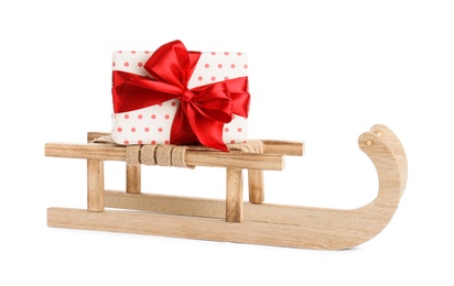Photo of Wooden sleigh with gift box isolated on white. Christmas holiday decor