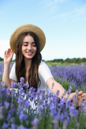 Photo of Young woman in lavender field on summer day