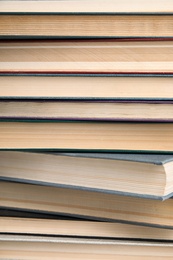 Stack of hardcover books as background, closeup