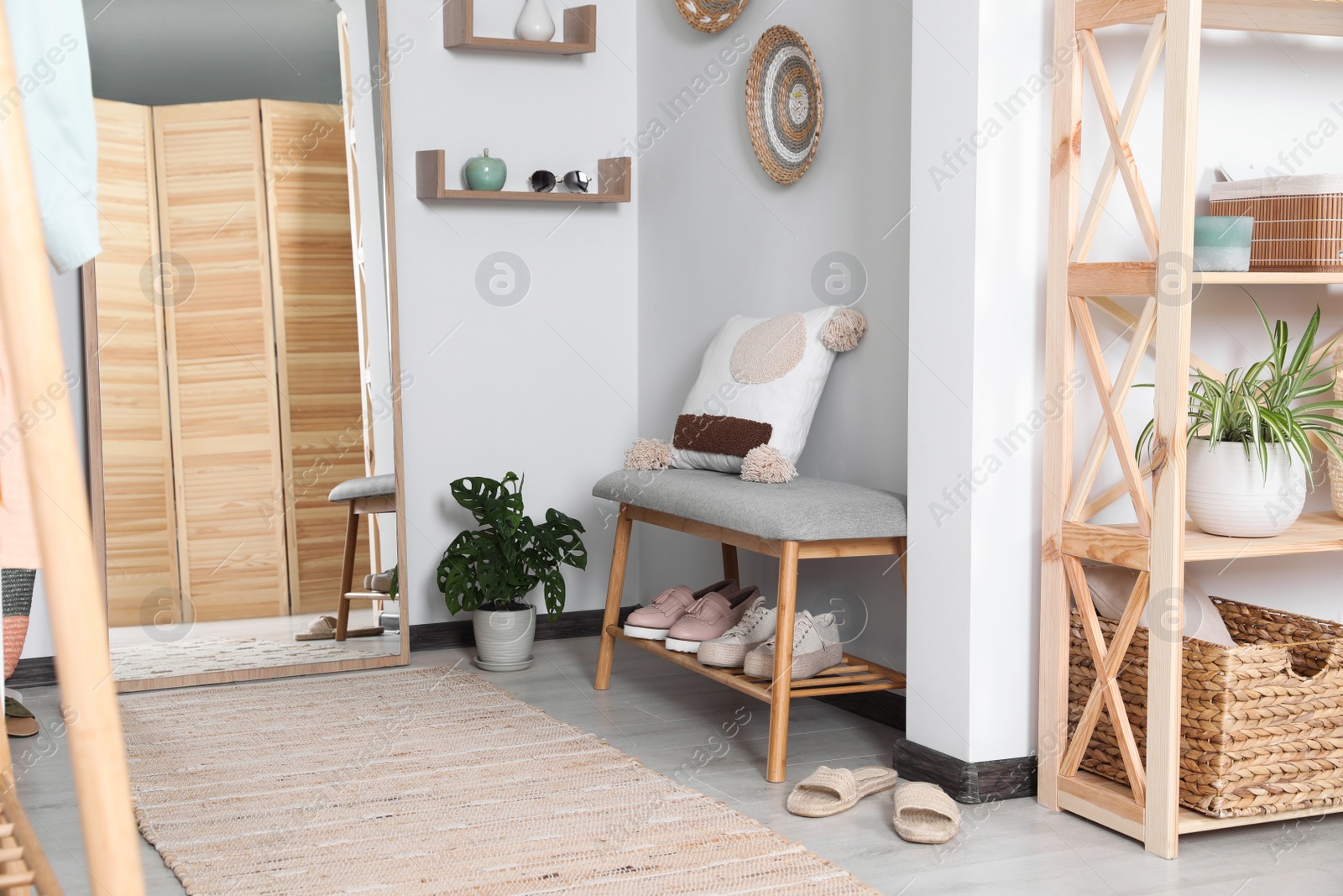 Photo of Hallway interior with shoe storage bench and floor mirror