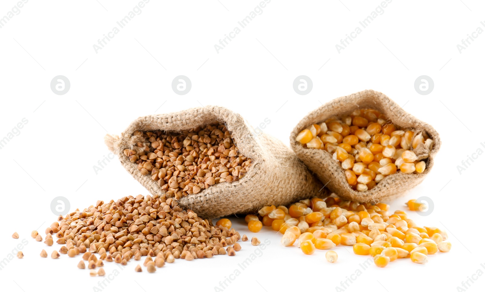 Photo of Bags with buckwheat and corn kernels on white background. Healthy grains and cereals