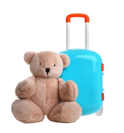 Photo of Stylish little blue suitcase with teddy bear on white background