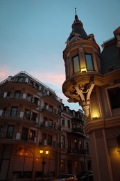 Beautiful buildings with illumination in evening, low angle view