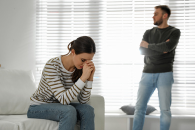 Photo of Young couple quarreling at home. Jealousy in relationship