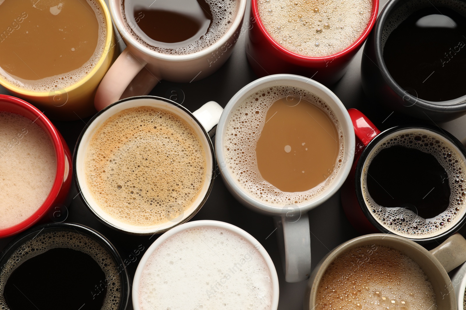 Photo of Many different cups with aromatic coffee on grey table, flat lay