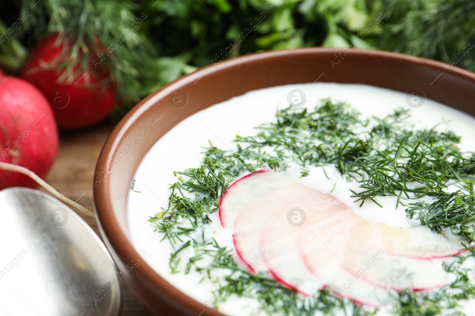 Photo of Delicious cold summer soup with kefir served on table, closeup