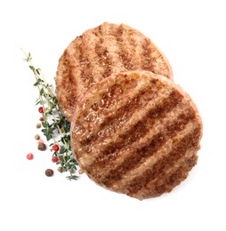 Tasty grilled hamburger patties with seasonings on white background, top view