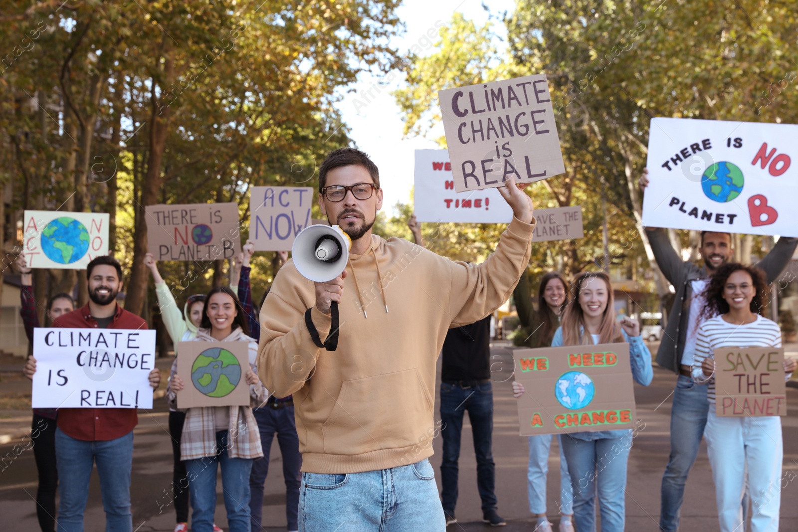 Photo of Group of people with posters protesting against climate change on city street