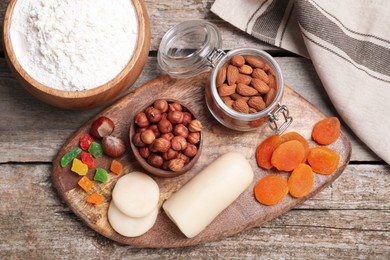 Marzipan and other ingredients for homemade Stollen on wooden table, flat lay. Baking traditional German Christmas bread