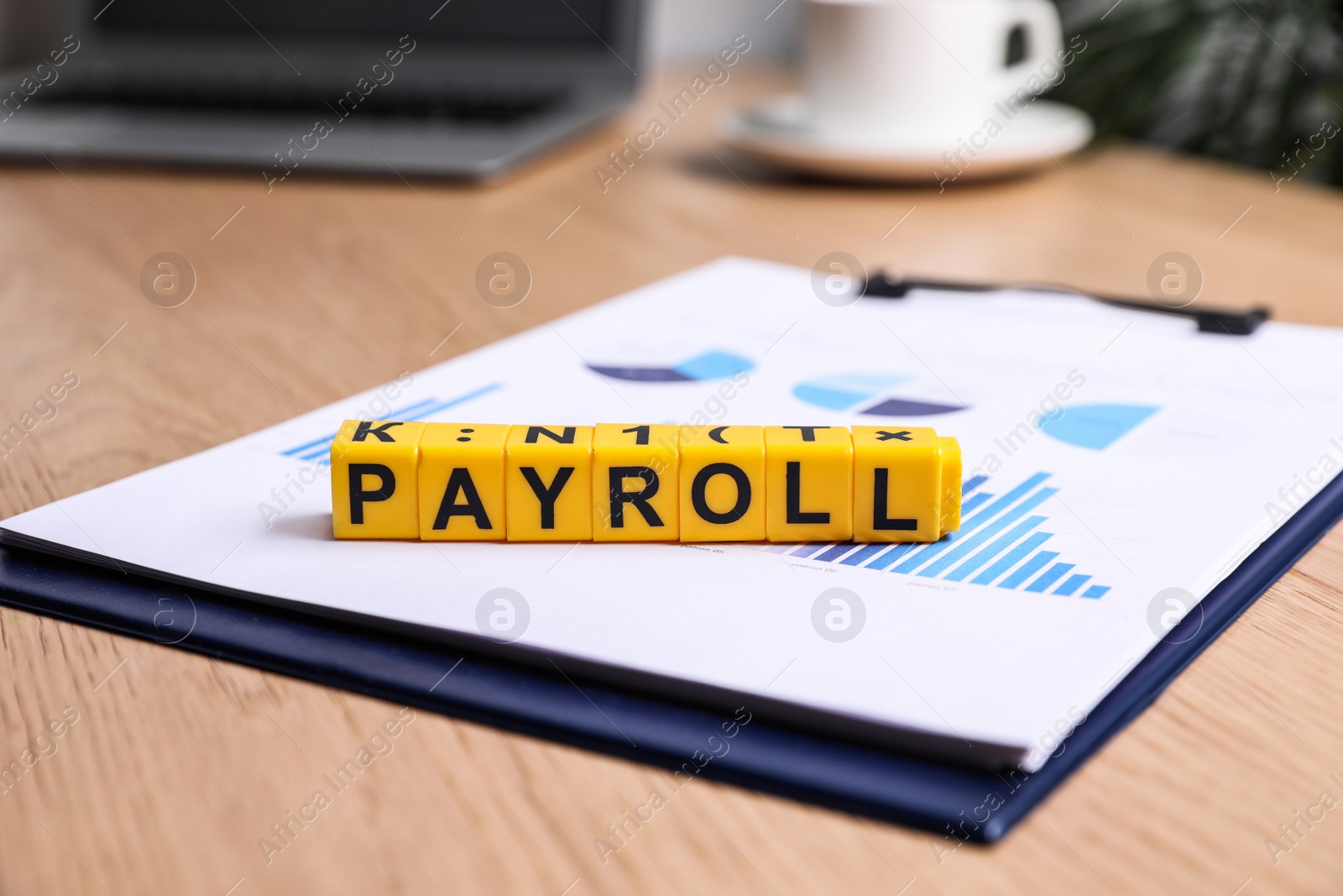 Photo of Cubes with word Payroll and chart on wooden table