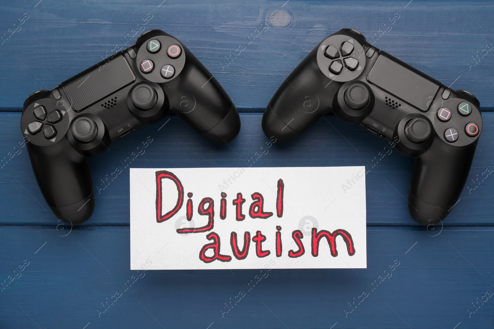 Photo of Card with phrase Digital Autism on blue wooden table, flat lay. Addictive behavior