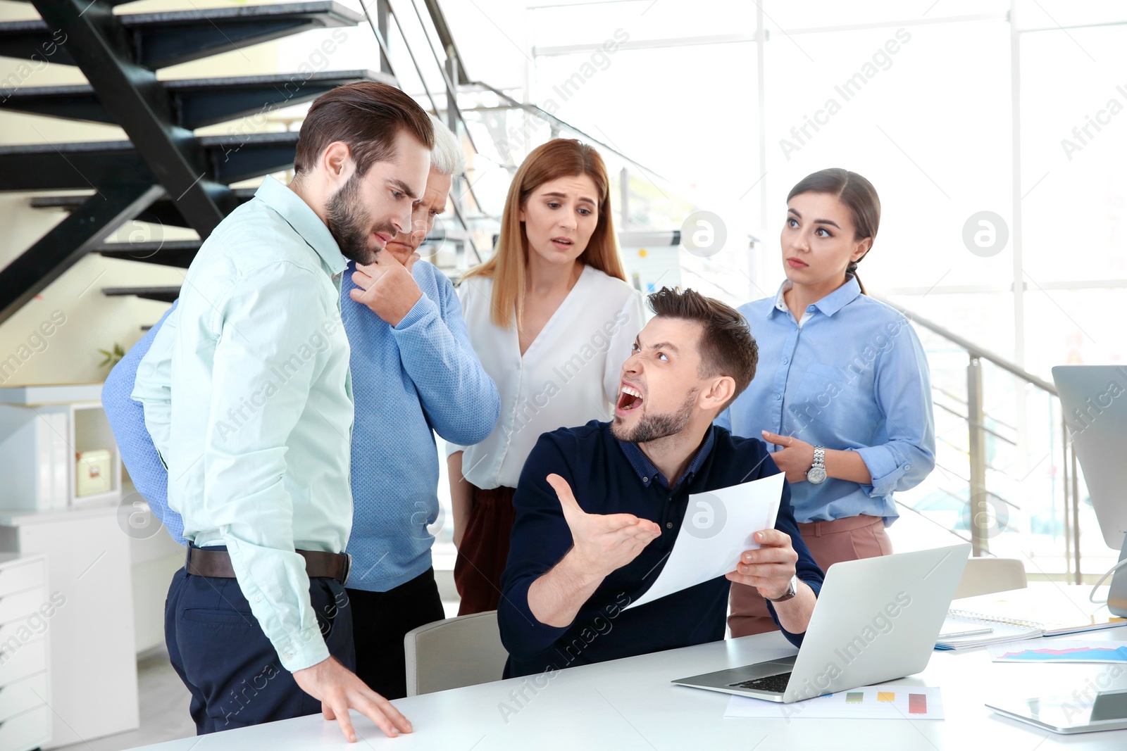 Photo of Office employees having argument during business meeting