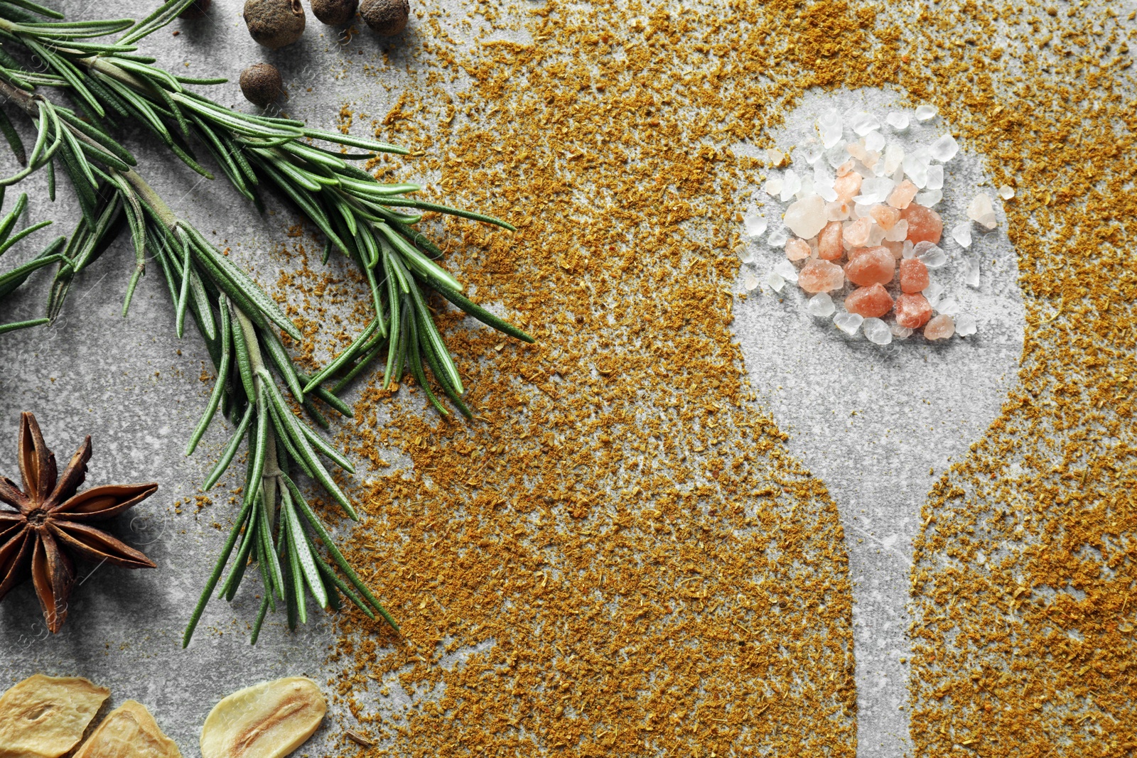 Photo of Different spices and silhouette of spoon light grey table, flat lay