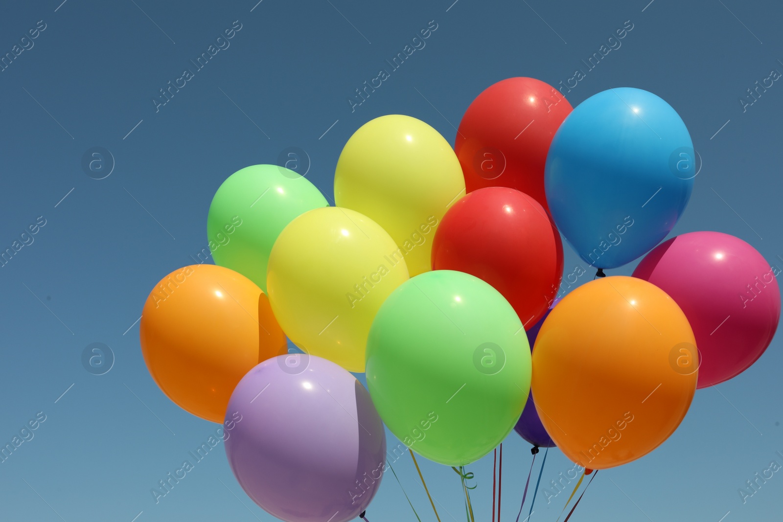 Photo of Bunch of colorful balloons against blue sky