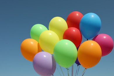 Bunch of colorful balloons against blue sky