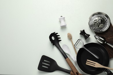 Photo of Set of different kitchen utensils on white table, flat lay. Space for text